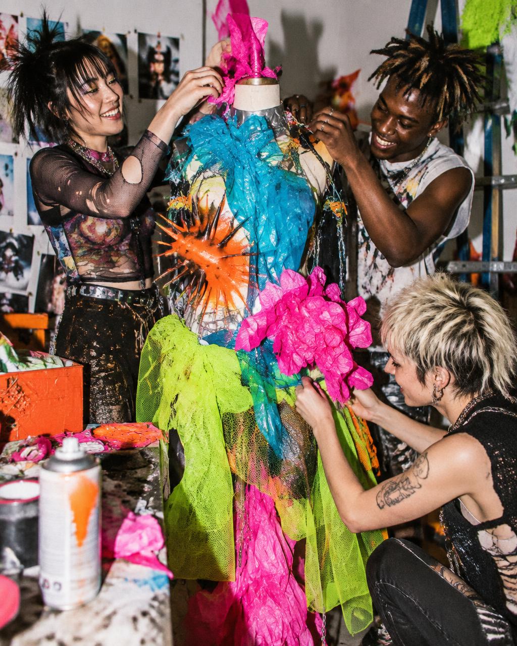 Creators building a vivid wearable sculpture together